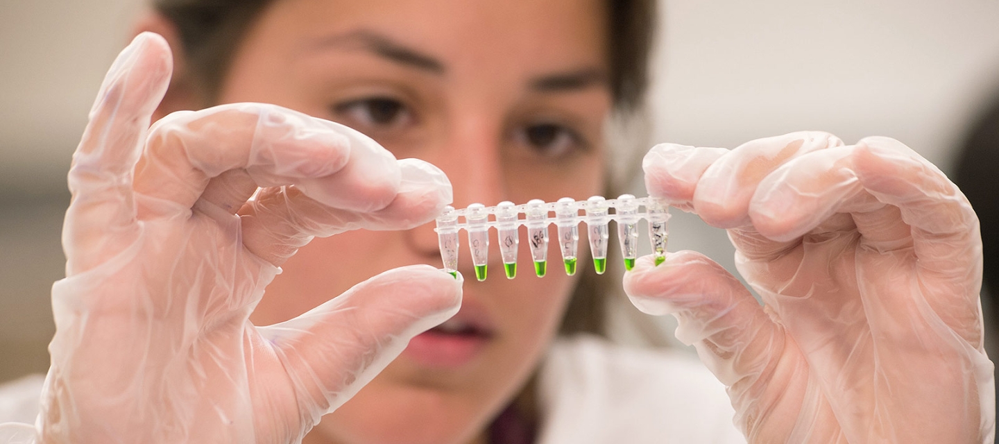 Biology student with lab sample